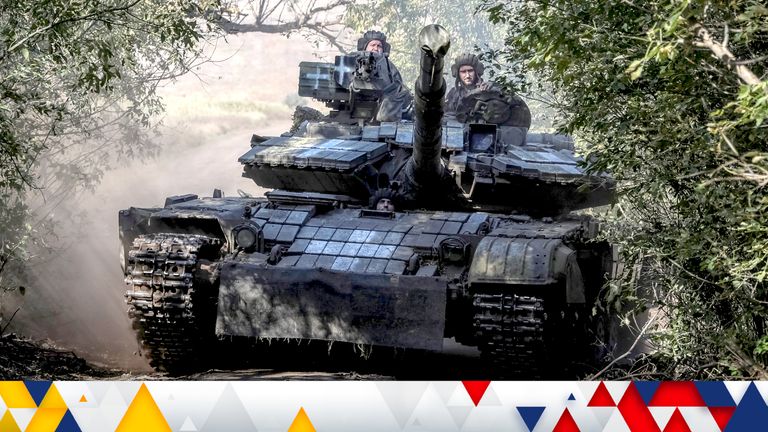 Ukrainian servicemen ride a tank in Donetsk region.