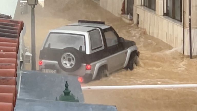 A vehicle is swept away by the current following torrential rain in Skiathos