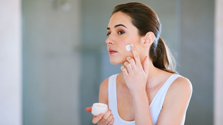 iStock image of woman using moisturiser 