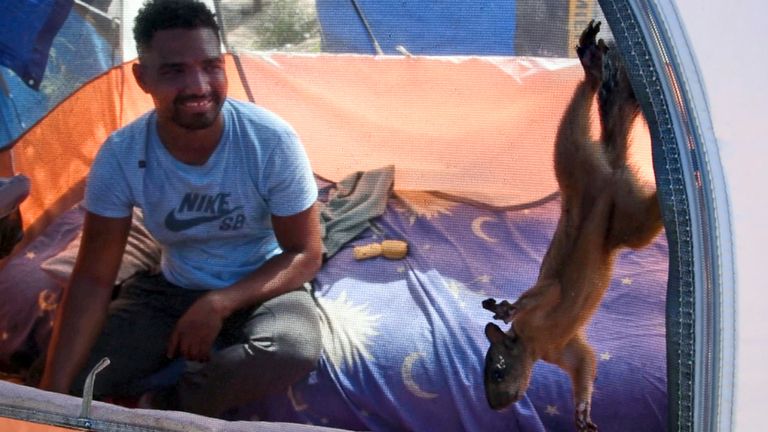 Niko, a pet squirrel, is fed by his owner, Yeison, in their tent at a migrant camp in Matamoros, Mexico. The pair travelled thousands of miles to the US border, but now may be separated if he is granted entrance to the US. Pic: AP/Valerie Gonzalez
