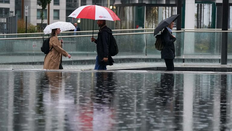 People walk by Centenary Square in Birmingham during a rainy morning. Strong winds and heavy rain are set to batter the UK as Storm Agnes sweeps across the country. Agnes, the first named storm of the season, will affect western regions of the UK and Ireland on Wednesday, with the most powerful winds expected on the Irish Sea coasts. Picture date: Tuesday September 26, 2023.