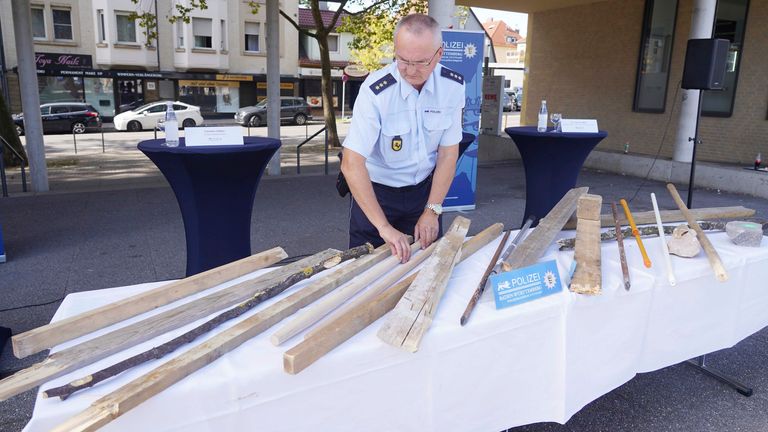 Police lay out sticks and battens used in the fighting