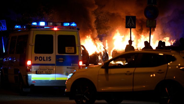 Cars burn during a riot in Malmo