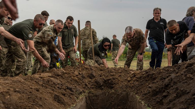 Ukrainian servicemen at the funeral of flight engineer Yuriy Anisimov. Pic: AP