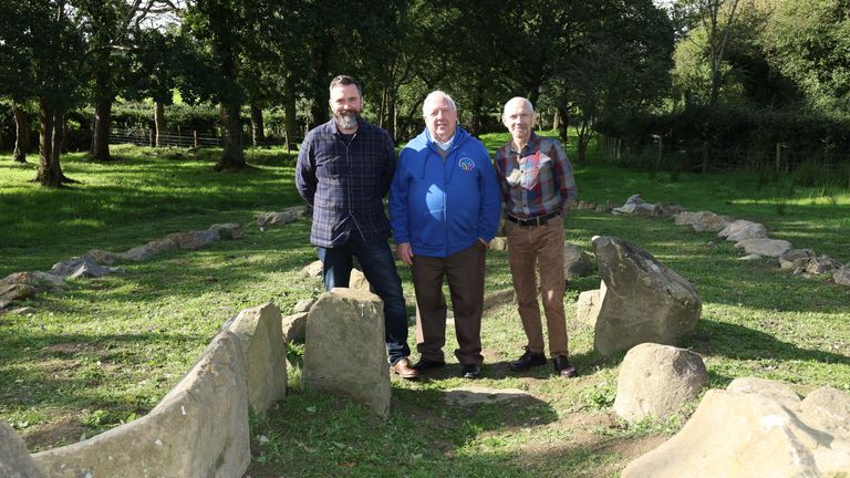 Undated handout photo of William Blair, director of collections at National Museums NI, Joe Garvey, chairman of the Richmount Rural Community Association in Portadown, and Dr Greer Ramsey, curator of archaeology at National Museums NI by the Ballintaggart Court Tomb. The court tomb which are older than Egypt&#39;s pyramids has secured a permanent new home on display at the Ulster Folk Museum. The 6,000-year-old tomb, which dates back to the Neolithic era, was discovered in Ballintaggart, Co Armagh. 