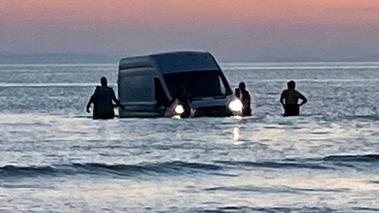 Van partly submerged in seawater on a beach in Porthmadog, Gwynedd. Pic: Sadie Wright