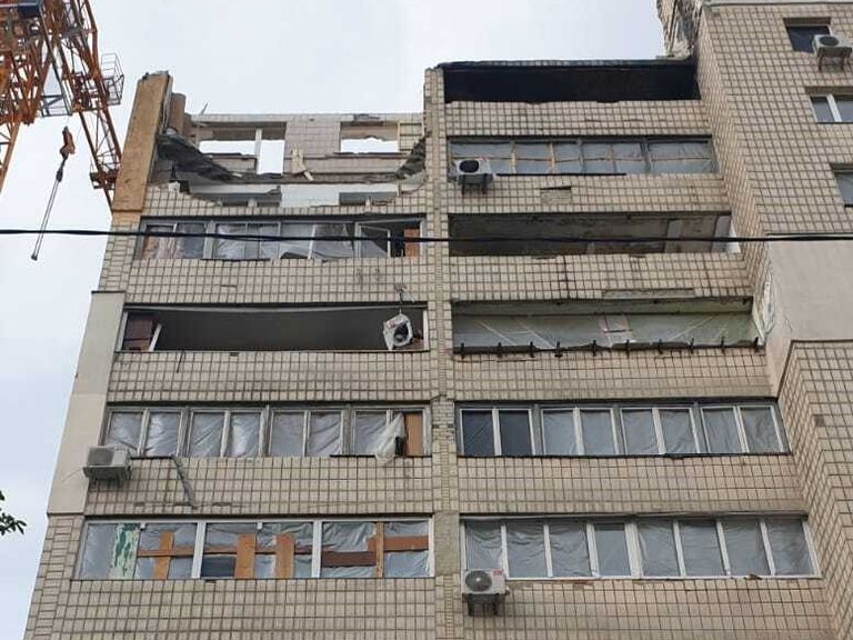 A neighbour&#39;s building is reconstructed after a missile attack in Kyiv