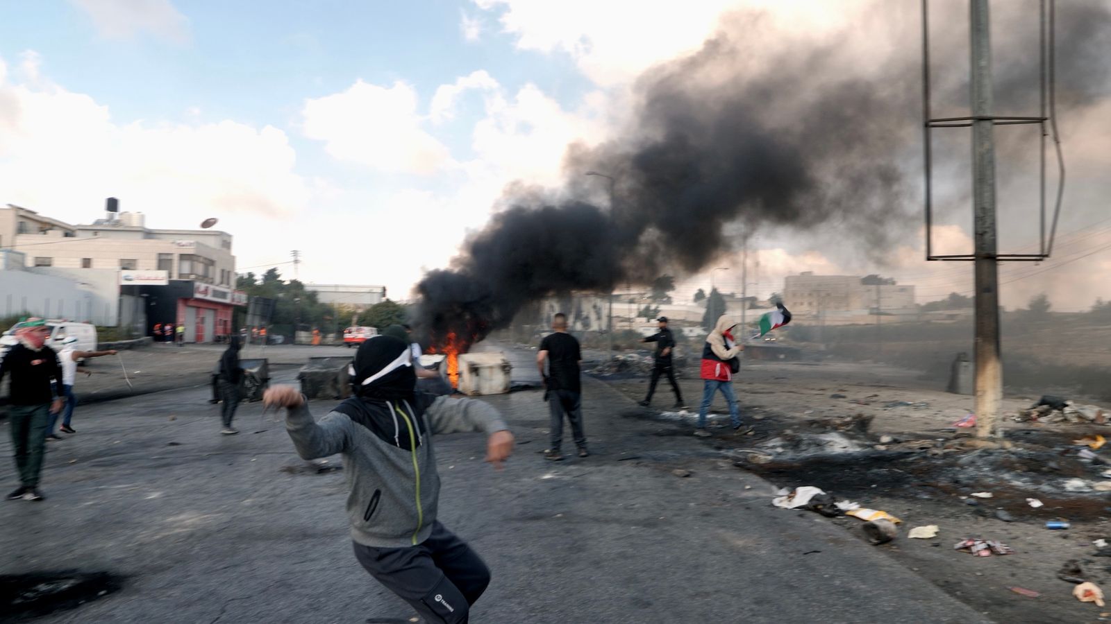 Изображение Момче хвърля камък сред протестите На Западния бряг в