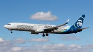 A Boeing 737 (737-900ER, registration N248AK) jetliner, belonging to Alaska Airlines and in livery for "Boeing 100 years strong", lands at Harry Reid (formerly McCarren) International Airport in Las Vegas, Nv., on Feb. 26, 2023. (Larry MacDougal via AP)
