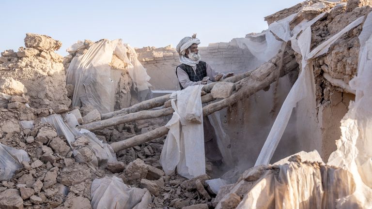 A man cleans up rubble after an earthquake in Zenda Jan district in Herat province, western Afghanistan
Pic:AP