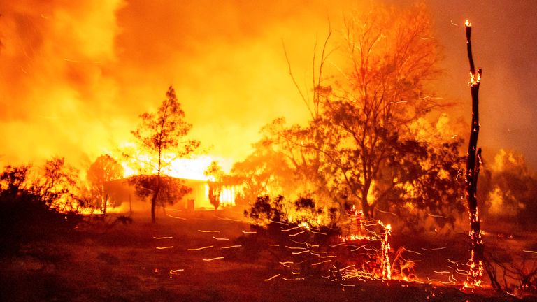 A structure is engulfed in flames as a wildfire called the Highland Fire burns in Aguanga, California
Pic:AP