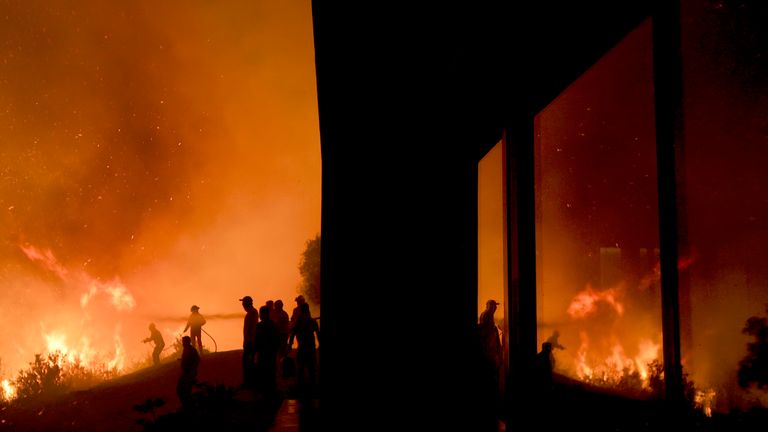 Firefighters work to put out a forest fire on the outskirts of Villa Carlos Paz, Cordoba province, Argentina
Pic:AP