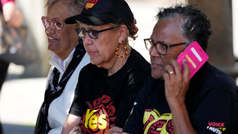 Indigenous women sat waiting for updates after casting their vote. Pic: AP