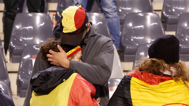 A supporter is comforted on the stands after suspension of the Euro 2024 group F qualifying soccer match between Belgium and Sweden at the King Baudouin Stadium in Brussels, Monday, Oct. 16, 2023. The match was abandoned at halftime after two Swedes were killed in a shooting in central Brussels before kickoff. (AP Photo/Geert Vanden Wijngaert)