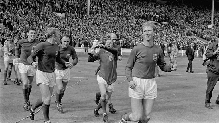 Jubilant England players parade the World Cup around Wembley after their 4-2 win: (l-r) Gordon Banks, Alan Ball, Martin Peters, Bobby Moore, George Cohen, Ray Wilson, Bobby Charlton, Jack Charlton. 