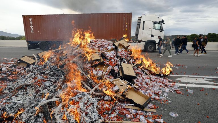 French winemakers destroy a shipment of tomatoes coming from Spain during a demonstration by the tollbooth in Le Boulou, near the Spanish border, south of France