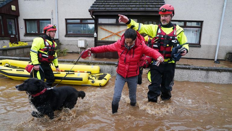 Members of the emergency services help a woman in Brechin 