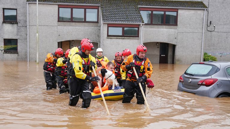 Members of the emergency services help local residents to safety in Brechin, Scotland, as Storm Babet batters the country 