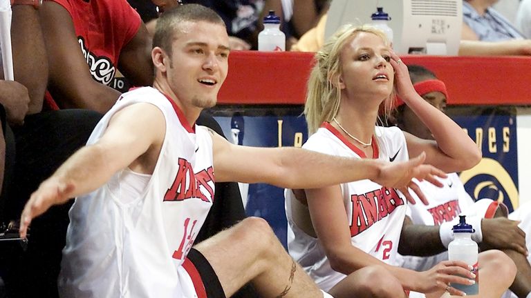 Singer Justin Timberlake (L) of " &#39;N Sync" and girlfriend, pop star Britney Spears, watch from the sidelines during a celebrity basketball game at the "Challenge for the Children III" event at the Thomas & Mack Center in Las Vegas July 29, 2001. 