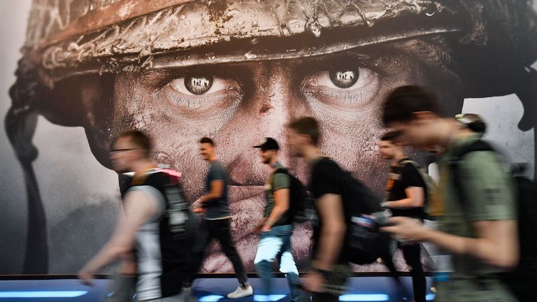 Visitors passing an advertisement for the video game Call Of Duty at the Gamescom fair for computer games in Cologne, Germany, Aug. 22, 2017. Microsoft has signed an agreement with Sony to keep the ...Call of Duty... video game series on PlayStation following the tech giant...s acquisition of the video game maker Activision Blizzard. The announcement was made Sunday, July 16, 2023 in a Twitter post by Phil Spencer, who heads up Microsoft...s Xbox. (AP Photo/Martin Meissner, File)