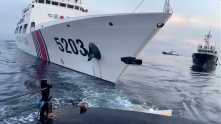 This image from a video released by the Armed Forces of the Philippines, shows a Chinese coast guard ship with bow number 5203 after bumping a Filipino supply boat as they approach Second Thomas Shoal, locally called Ayungin Shoal, at the disputed South China Sea on Sunday Oct. 22, 2023. (Armed Forces of the Philippines via AP)