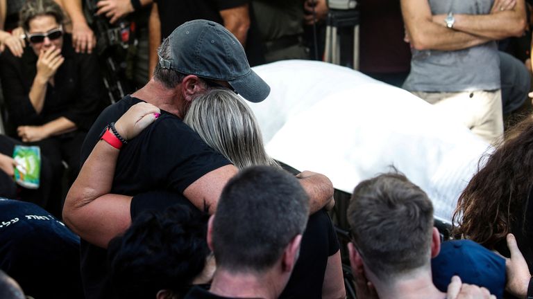 Family and friends mourn Danielle, 25, and Noam, 26, an Israeli couple who were killed in a deadly attack by Hamas gunmen from Gaza as they attended a festival, as they are buried next to each other at their funeral in Kiryat Tivon, Israel, October 12, 2023. REUTERS/Shir Torem
