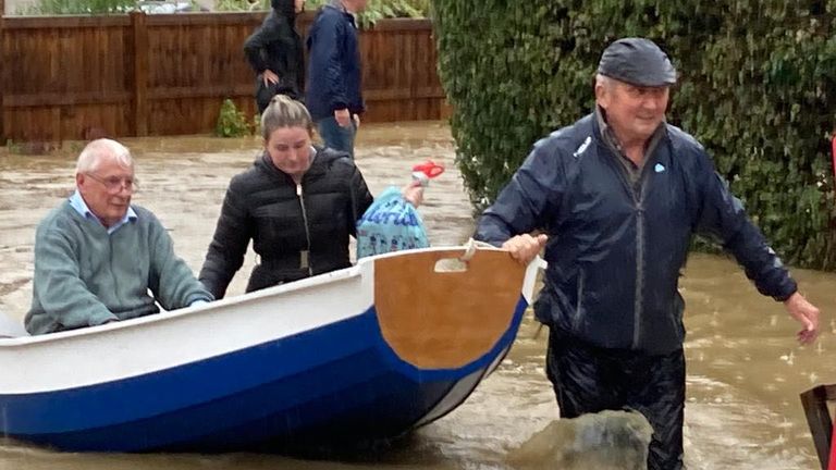 A man uses his homemade boat to rescue elderly residents from their home in the village of Debenham, Suffolk