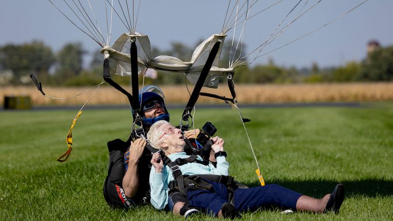 Dorothy Hoffner, 104, comes in for a landing as she becomes the oldest person in the world to skydive with tandem jumper Derek Baxter on Sunday, Oct. 1, 2023, at Skydive Chicago in Ottawa, Ill. (Brian Cassella/Chicago Tribune via AP)