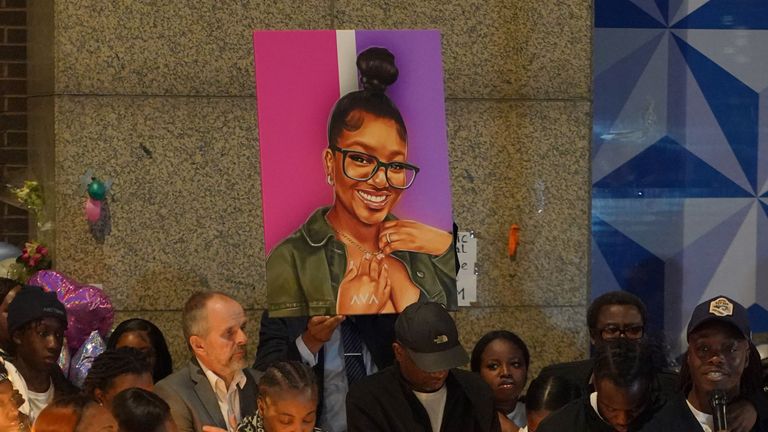 A picture of Elianne Andam is held aloft at a vigil in her memory in Croydon, south London