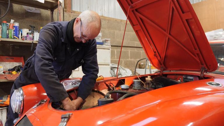 Classic EVS stills of mechanics working on a conventional engine