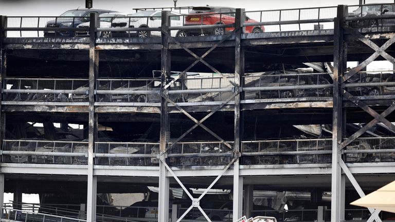 A view shows burnt vehicles in Terminal Car Park 2, following a fire at London Luton Airport, in Luton, Britain, October 11, 2023. REUTERS/Peter Cziborra
