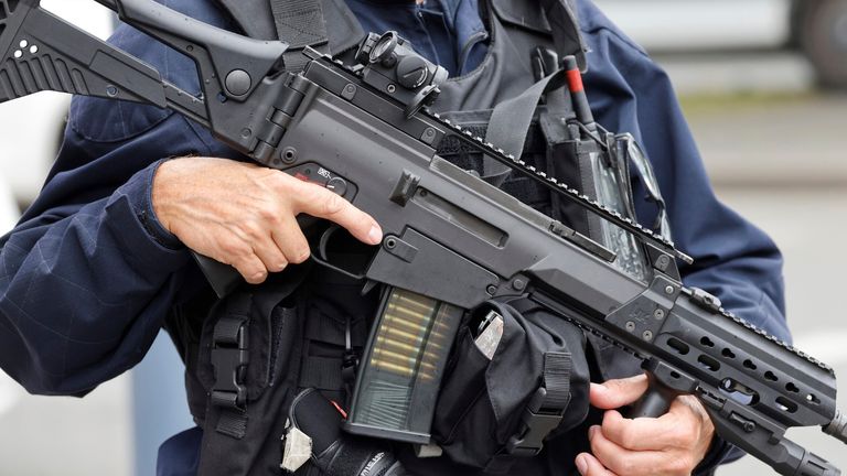 A police officer holds a HK G36 assault rifle at the Gambetta high school in Arras, northeastern France, Friday Oct. 13, 2023. A man of Chechen origin who was under surveillance by the French security services stabbed a teacher to death at his former high school and critically wounded two other people in northern France on Friday, authorities said. (Ludovic Marin, Pool via AP)


