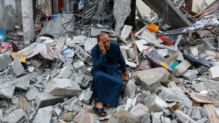 A Palestinian sits on the rubble of a building destroyed in Israeli strikes, in Rafah in the southern Gaza Strip October 9, 2023. REUTERS/Ibraheem Abu Mustafa