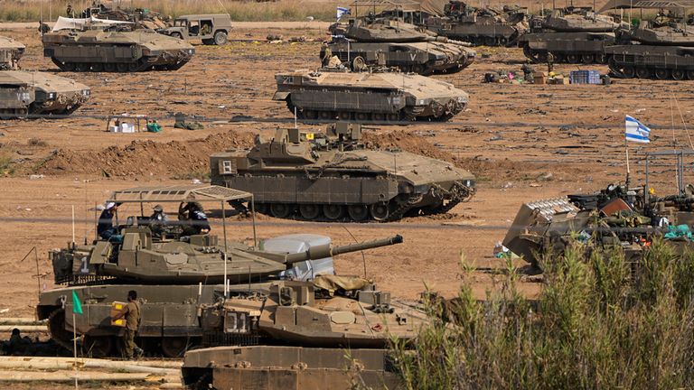 Israeli soldiers gather in a staging area near the border with Gaza Strip, in southern Israel, Tuesday, Oct. 24, 2023. (AP Photo/Ohad Zwigenberg)