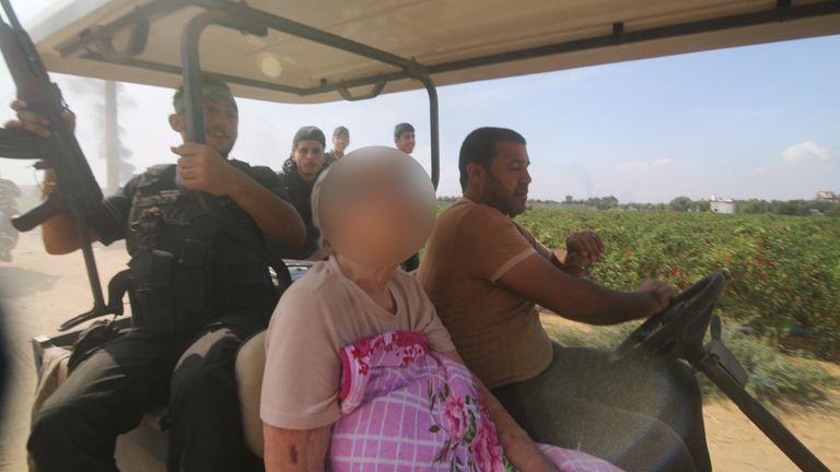 Palestinians transport a captured Israeli civilian. Pic: AP
