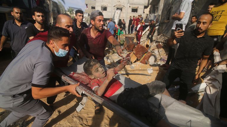 Palestinians pull a boy from the rubble after an Israeli strike on the Zaroub family house in Rafah, Gaza Strip. Pic: AP