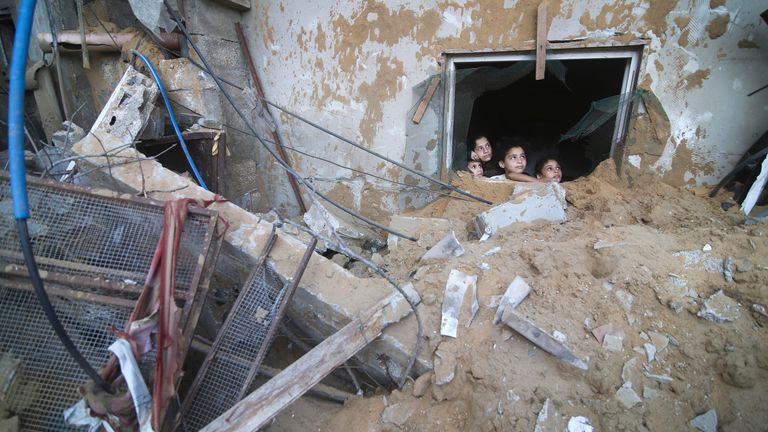 Palestinian children look at the building of the Zanon family, destroyed in Israeli airstrikes in Rafah, Gaza Strip 
Pic:AP
