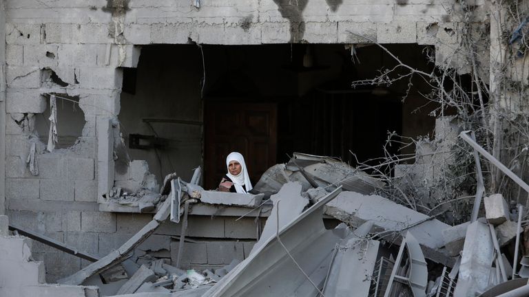 A Palestinian woman looks out of her window after an Israeli strike on the Gaza Strip in Rafah on Saturday. Pic: AP