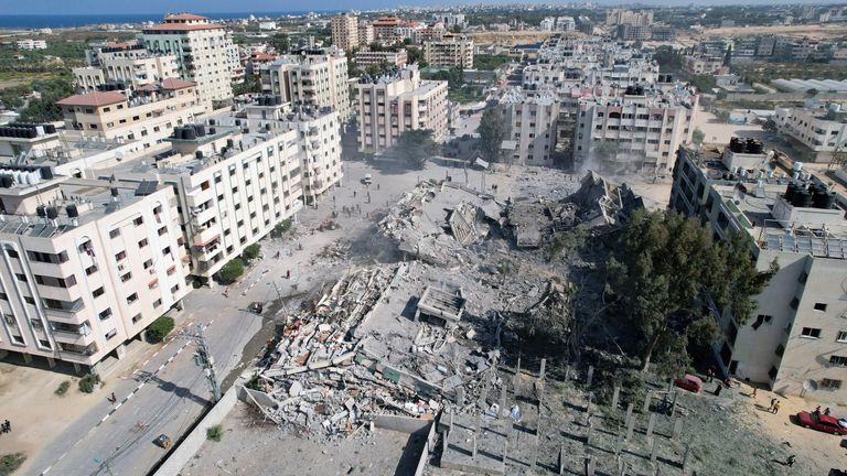 Palestinians gather around residential buildings destroyed in Israeli strikes in Zahra City in southern Gaza City