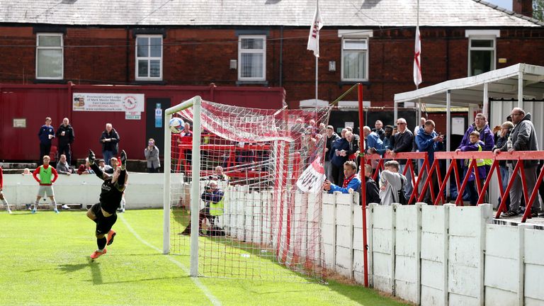 Fans look on as Ashton United score their third goal during the pre-season friendly match at Hurst Cross Stadium, Greater Manchester.
