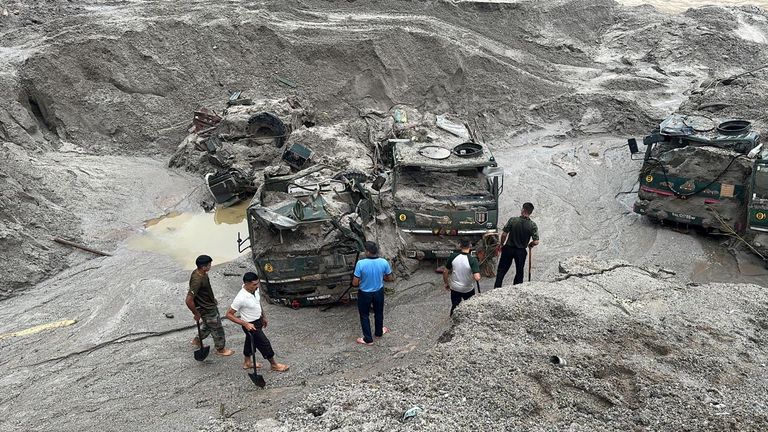 Members of Indian Army try to recover trucks buried at the area affected by flood in Sikkim in this undated image released by the Indian Army on October 5, 2023. India Army/Handout via REUTERS THIS IMAGE HAS BEEN SUPPLIED BY A THIRD PARTY. NO RESALES. NO ARCHIVES.
