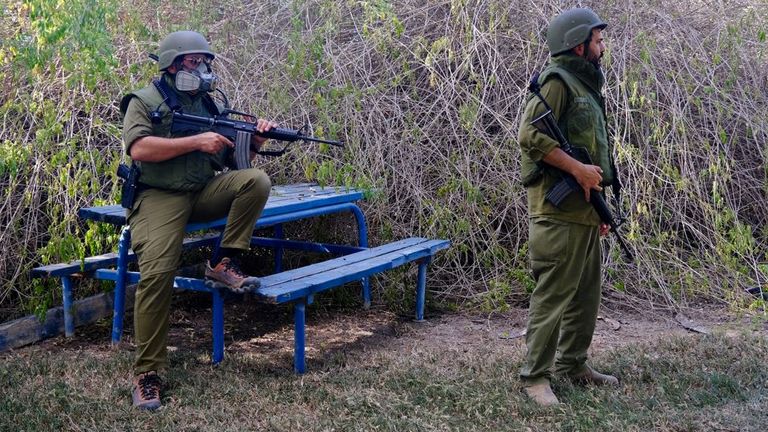 Soldiers guard the team as they work