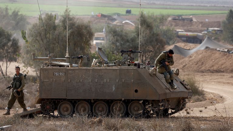 Israeli soldiers jump from an armoured personnel carrier (APC), amid the ongoing conflict between Israel and Hamas, near the border between Israel and Gaza Strip, in Israel, October 31, 2023. REUTERS/Amir Cohen