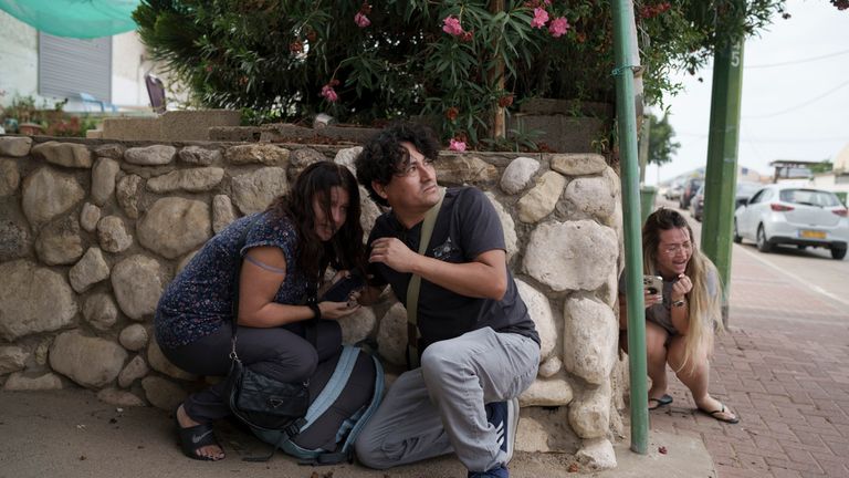 Israelis take cover from the incoming rocket fire from the Gaza Strip in Ashkelon, southern Israel. Pic: AP
