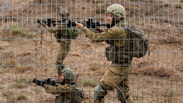 Israeli soldiers scan an area while sirens sound as rockets from Gaza are launched towards Israel, near Sderot, southern Israel, October 9, 2023. REUTERS/Amir Cohen