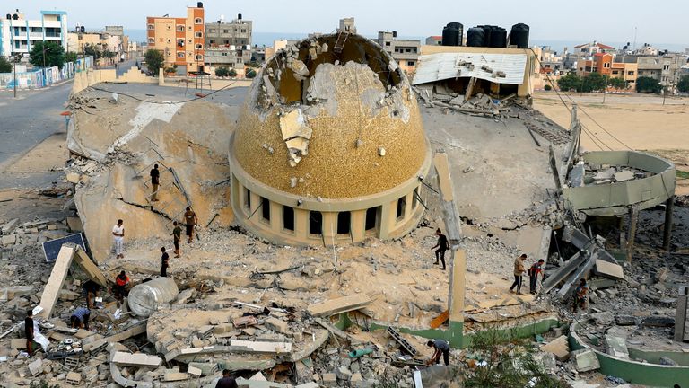 Palestinians inspect a mosque destroyed in Israeli strikes in Khan Younis, in the Gaza Strip