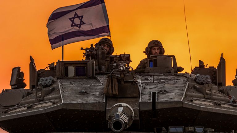 Israeli soldiers on a tank near the Israel-Gaza border. Pic: AP