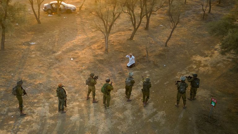 Israeli soldiers surround a Palestinian who ran at them with a knife at the site of a music festival near the border with the Gaza Strip. Pic: AP