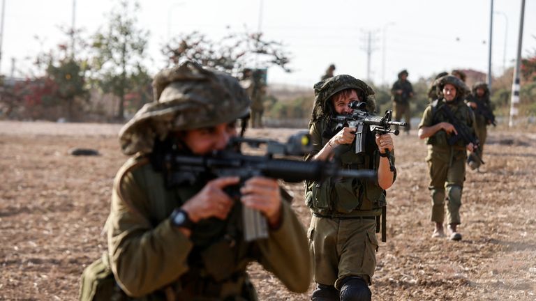 Israeli soldiers take position near Israel's border with Gaza