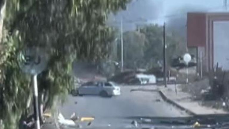 A tank fired toward a car on a main road in Gaza on October 30, amid Israeli ground operations.